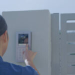 Healthcare worker pushing smart doorbell for a home visit